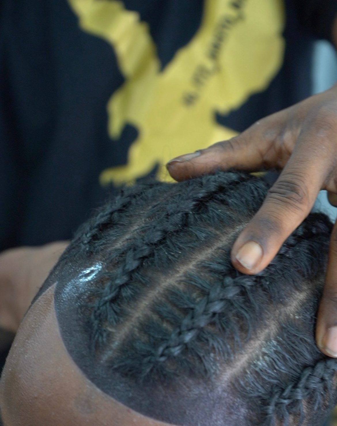 Close-up of cornrows with a hard part at the temple